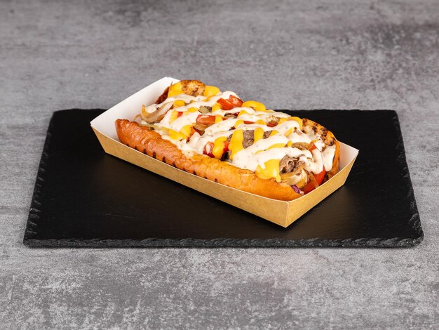 Hot dog grigliati gourmet con salsa di manzo e peperoni cipolle e patatine fritte