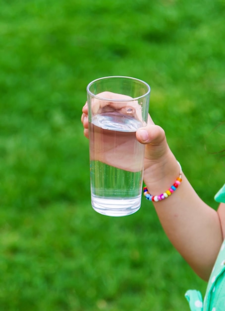 I bambini bevono acqua pulita con attenzione naturale