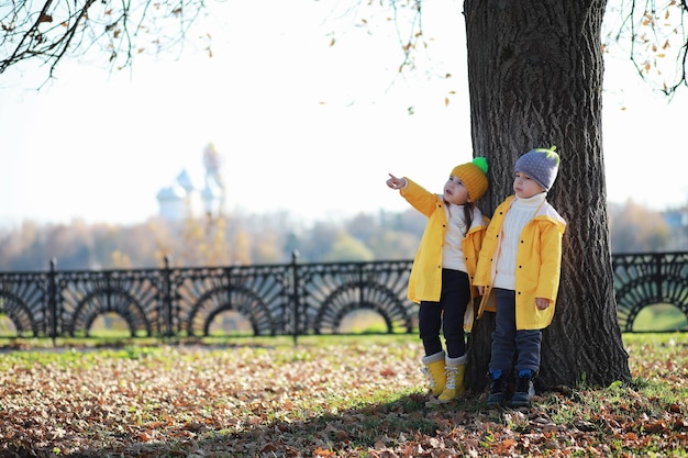 I bambini camminano nel parco autunnale