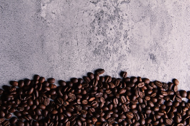 I chicchi di caffè tostato sono raccolti sul lato inferiore del tavolo delle texture