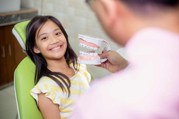 I denti delle bambine asiatiche sono sani nello studio dentistico Cure dentistiche Cure dentistiche
