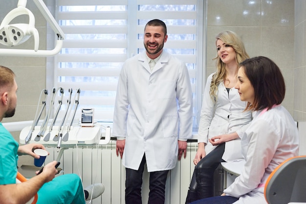 I giovani dentisti caucasici raggruppano sull&#39;intervallo per il caffè