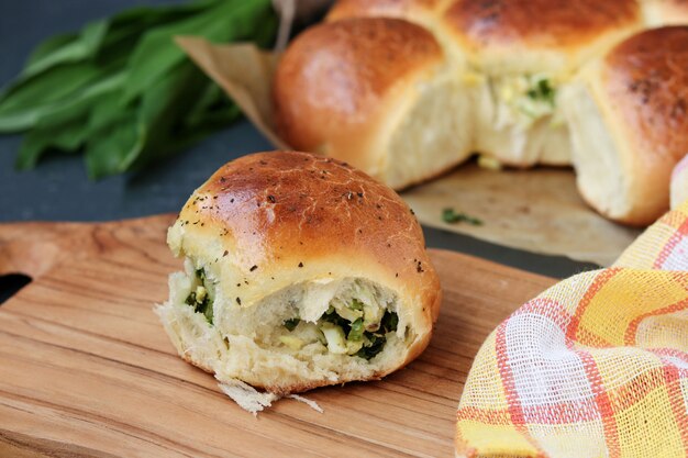 I panini di lievito ripieni di verdure e uova sode si trovano su una tavola di legno