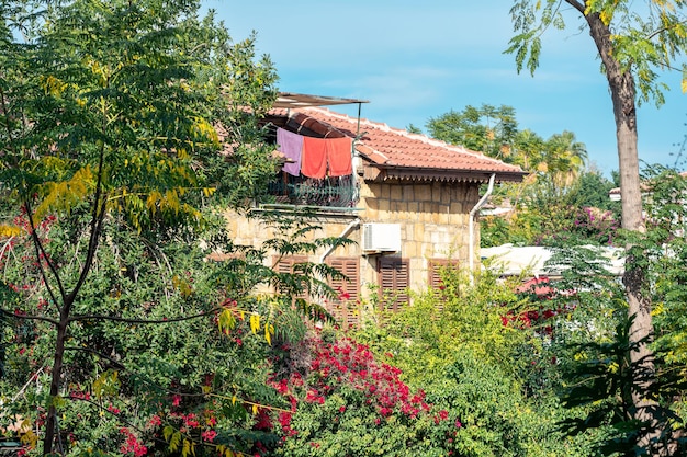 I teli mare stanno asciugando sul balcone della mansarda in una cittadina mediterranea immersa nel verde