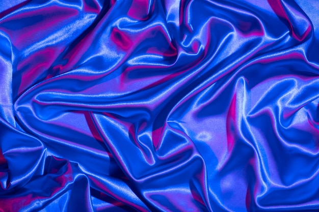 I tessuti si piegano in luce neon bluepink Colori alla moda e sfondo astratto lucido
