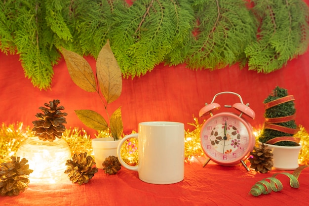 Idea di concetto minimalista che mostra i prodotti. tazza da caffè su sfondo di natale e capodanno.rosso, luci, fiori di pino