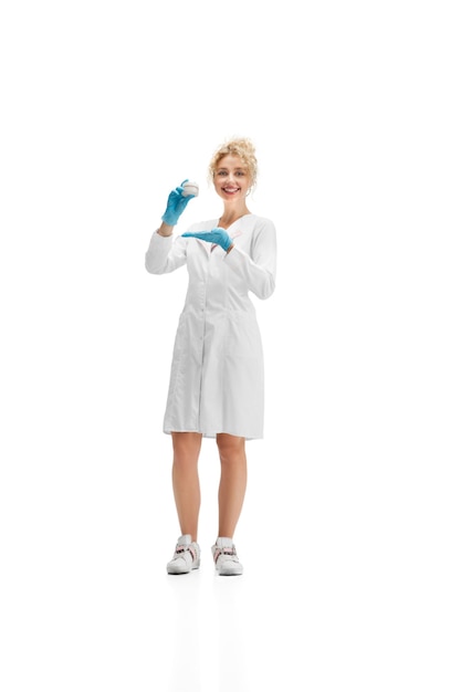 Idratante. Ritratto di dottoressa, infermiere o cosmetologo in uniforme bianca e guanti blu su sfondo bianco per studio. Copyspace per l'annuncio. Concetto di sanità e medicina, bellezza, cura di sé.