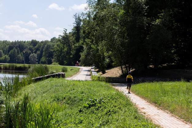 Il bambino corre nel parco lungo la strada