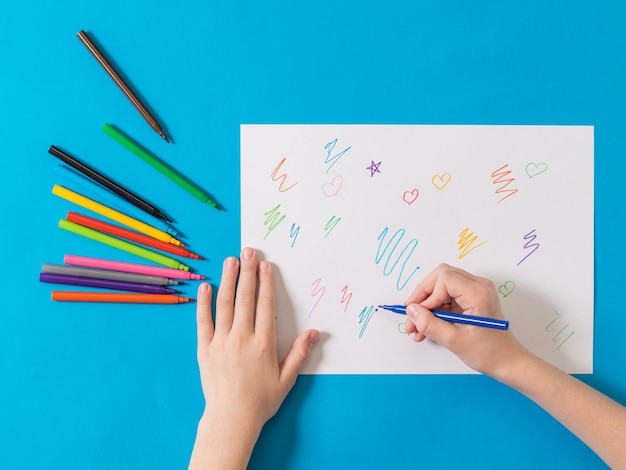 Il bambino disegna con pennarelli colorati su foglio bianco Pennarelli universali per ufficio scolastico e hobby