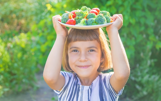 Il bambino mangia verdure broccoli e carote