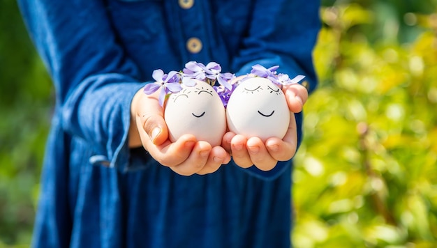 Il bambino tiene le uova di Pasqua nelle sue mani. Messa a fuoco selettiva. Ragazzo.