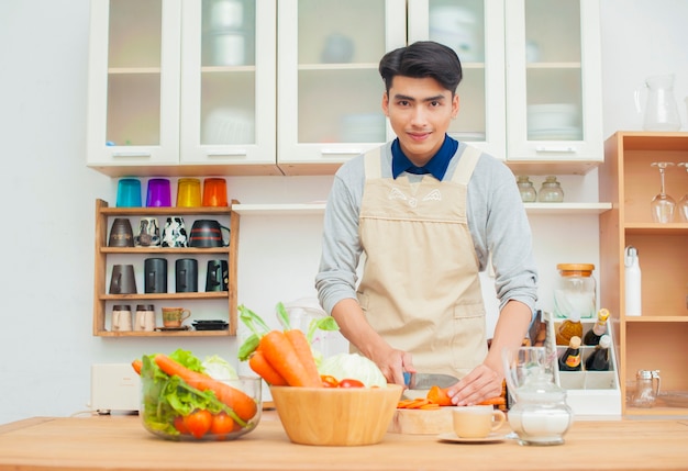 Il bell&#39;uomo sta cucinando in cucina.