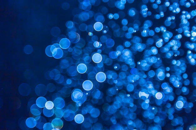 Il bokeh blu di scintillio accende il fondo defocused del bokeh