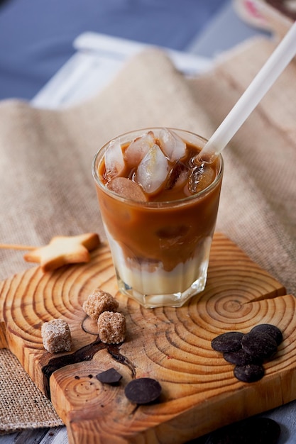 Il caffè freddo di Hong Kong in un bicchiere con un interessante fondo di legno di paglia