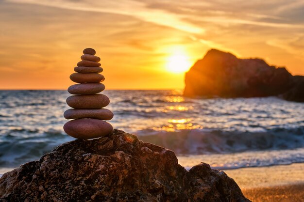 Il concetto di equilibrio e armonia stacca pietre sulla spiaggia.
