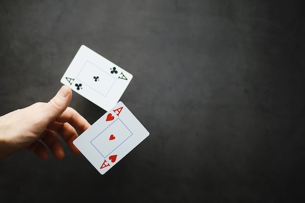 Il concetto di trucchi con le carte e presentazioni. Il concetto di pennarello nei giochi. Carte volanti in aria. Un mago alza le carte con la forza del pensiero.