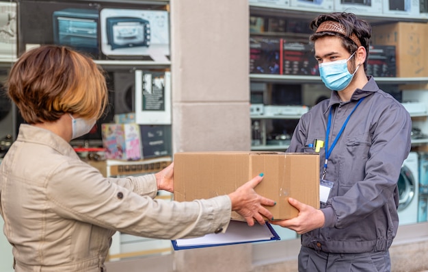 Il corriere consegna consegna il pacco alla donna