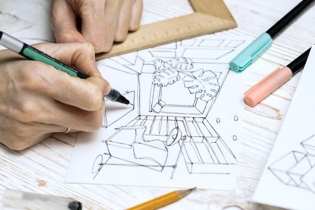 Il designer fa uno schizzo degli interni. sfondo - disegno, pennarelli, matita, gomma, righello, calcolatrice