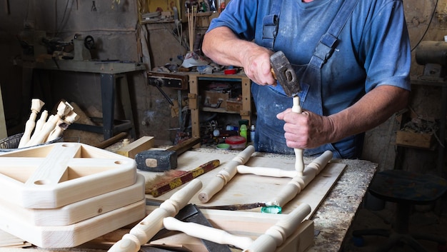 il falegname assembla una sedia di legno su un banco da lavoro