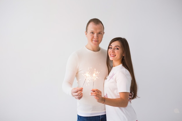 Il giorno di San Valentino concetto giovane allegra coppia attraente sorridente felice che celebra con le stelle filanti su