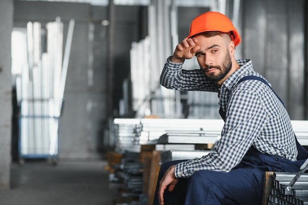 Il lavoratore lavora sodo Ingegnere stanco lavoro in fabbrica Uomo che lavora nell'area di pericolo Lavoro dei dipendenti