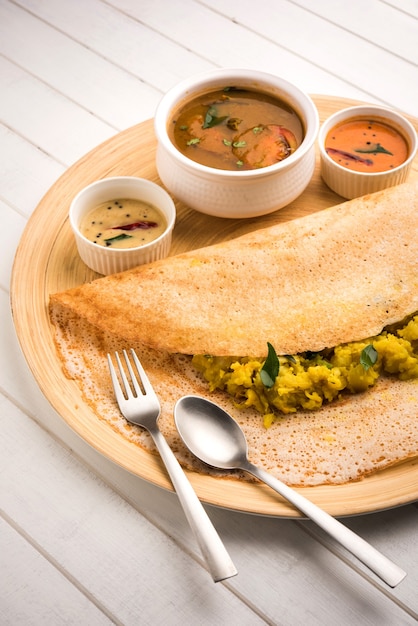 Il masala dosa è un pasto dell'India meridionale servito con sambhar e chutney di cocco. Messa a fuoco selettiva