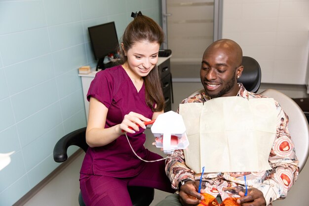 Il medico cura i denti del paziente nella moderna clinica odontoiatrica