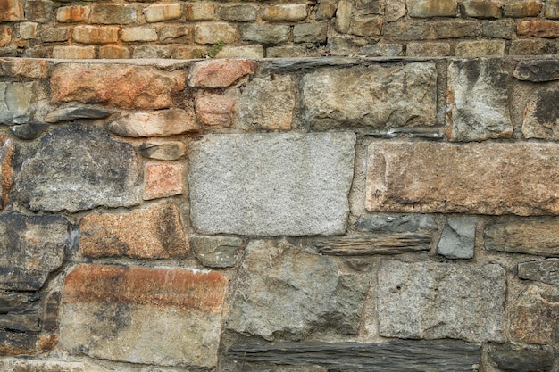 il muro di pietra rustico e senza tempo offre una profondità strutturale che simboleggia la forza, la stabilità e la fine