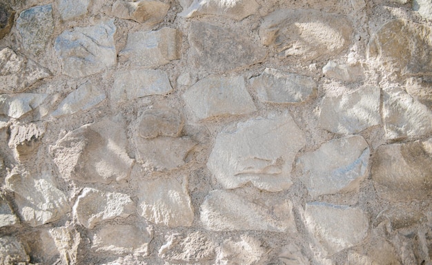 Il muro è grigioSfondo astrattoLa trama di un muro di pietra Un muro di pietra