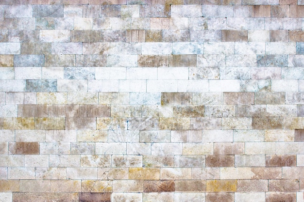 Il muro grigio di blocchi di pietra mattoni texture leggera come sfondo