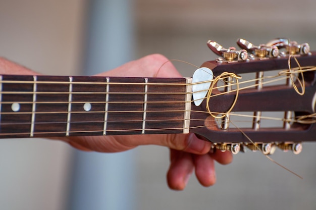 Il musicista suona la chitarra acustica Primo piano della mano del musicista