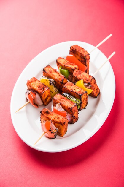 Il Paneer Tikka Kabab in salsa rossa è un piatto indiano fatto con pezzi di ricotta