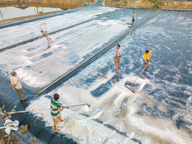 Il processo del sale marino ottenuto da un mucchio di sale nella salina da parte di un lavoratore del sale nell'area rurale di Long Dien Ba Ria Vung Tau Salt Fields è una delle destinazioni più singolari del Viet Nam