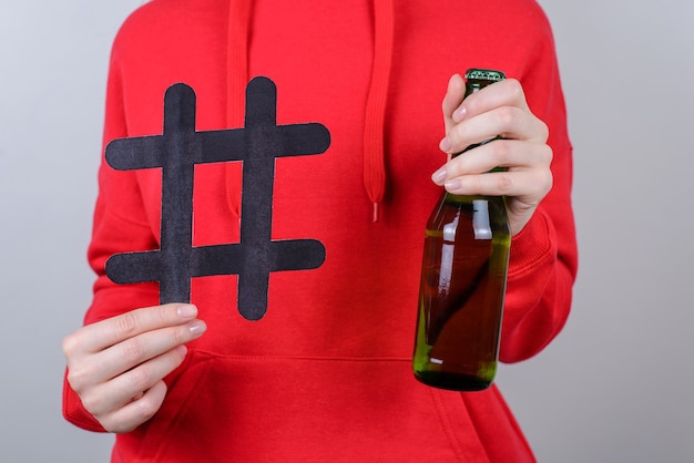 Il resto dell'azienda degli amici si rilassa il concetto di Internet in linea dell'adolescente di dipendenza da alcolismo di pausa chill. La foto ritagliata del primo piano della persona adolescente tiene la parete grigia isolata del pullover rosso di usura di vetro