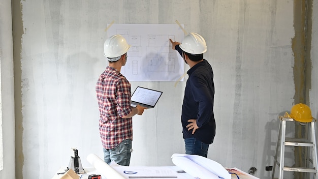 Il team di ingegneri discute e lavora al cantiere della proprietà. Ispezione al progetto del villaggio e alla costruzione della proprietà.