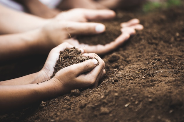 Il terreno della tenuta del genitore e del bambino a forma di cuore prepara per piantare