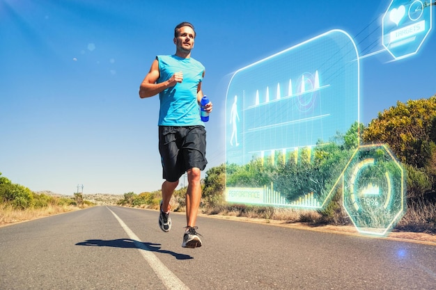 Immagine composita dell'uomo atletico che fa jogging sulla strada aperta che tiene la bottiglia