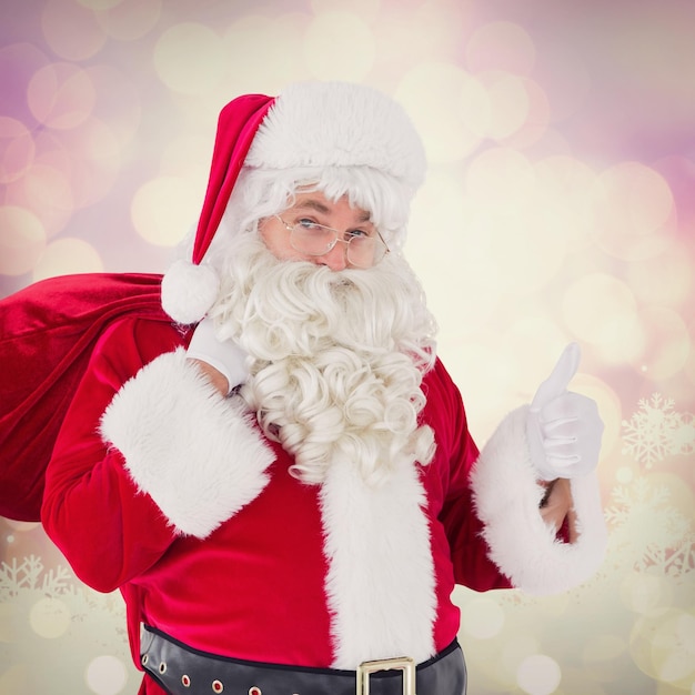 Immagine composita di Babbo Natale con il suo sacco e i pollici in su
