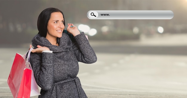 Immagine composita digitalmente della donna che tiene la borsa della spesa e una barra di ricerca