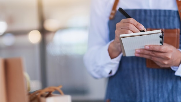 Immagine del primo piano di un'imprenditrice che controlla gli ordini dal cliente