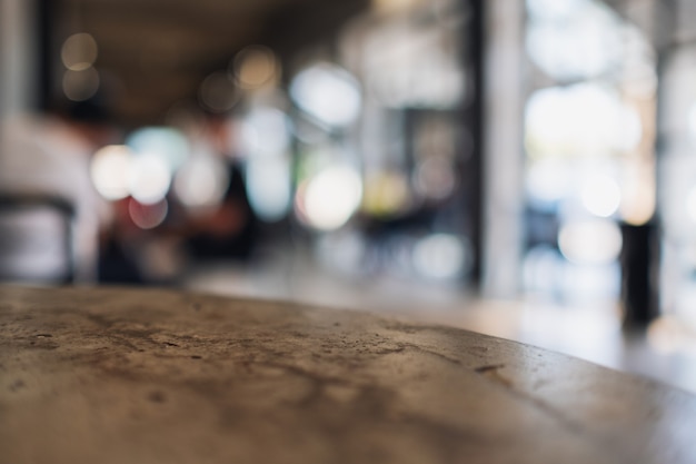 Immagine del primo piano di un tavolo di cemento con sfondo sfocato in cafe