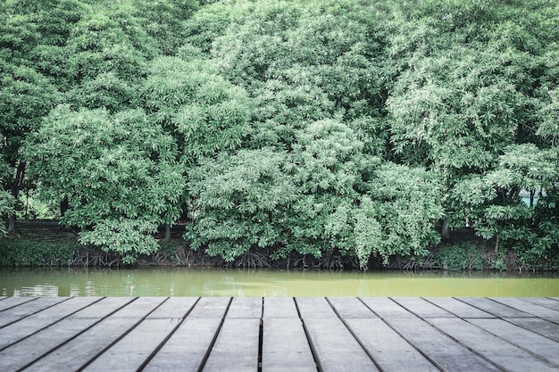 Immagine della tavola di legno davanti agli alberi verdi, concetti della natura.