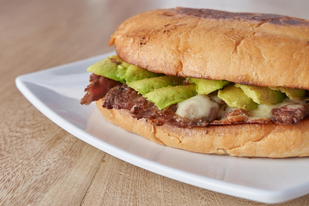 Immagine di delizioso panino o torta con carne avocado e formaggio tipico cibo messicano torta di roast beef