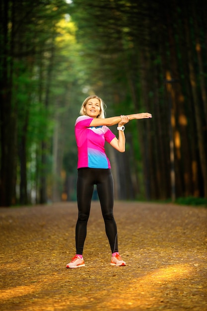 Immagine di una giovane ragazza che si allunga nel parco estivo nel pomeriggio