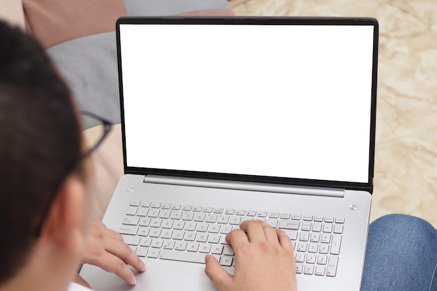 Immagine ravvicinata di un computer portatile con schermo bianco. Uomo che scrive sul laptop.