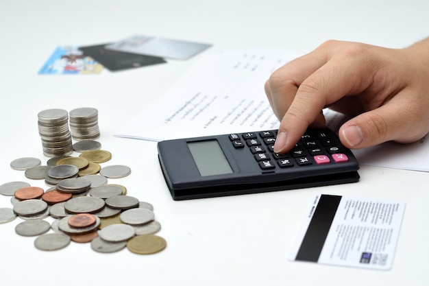 Immagine ritagliata di mano che calcola le finanze su sfondo bianco