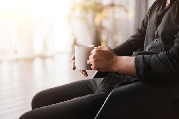 Immagine ritagliata di un uomo d'affari con una tazza di caffè