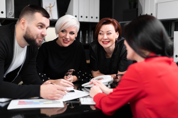 Impiegati sorridenti che parlano nel posto di lavoro