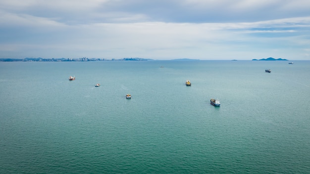 Importazione ed esportazione della nave da carico del contenitore di paesaggi marini con la vista aerea del cielo della nuvola