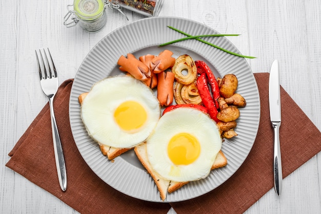 Impostare per colazione uova fritte, verdure grigliate e salsicce